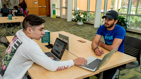 two students working on a computer