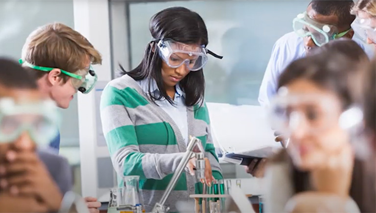 high school girl working in a chemistry lab