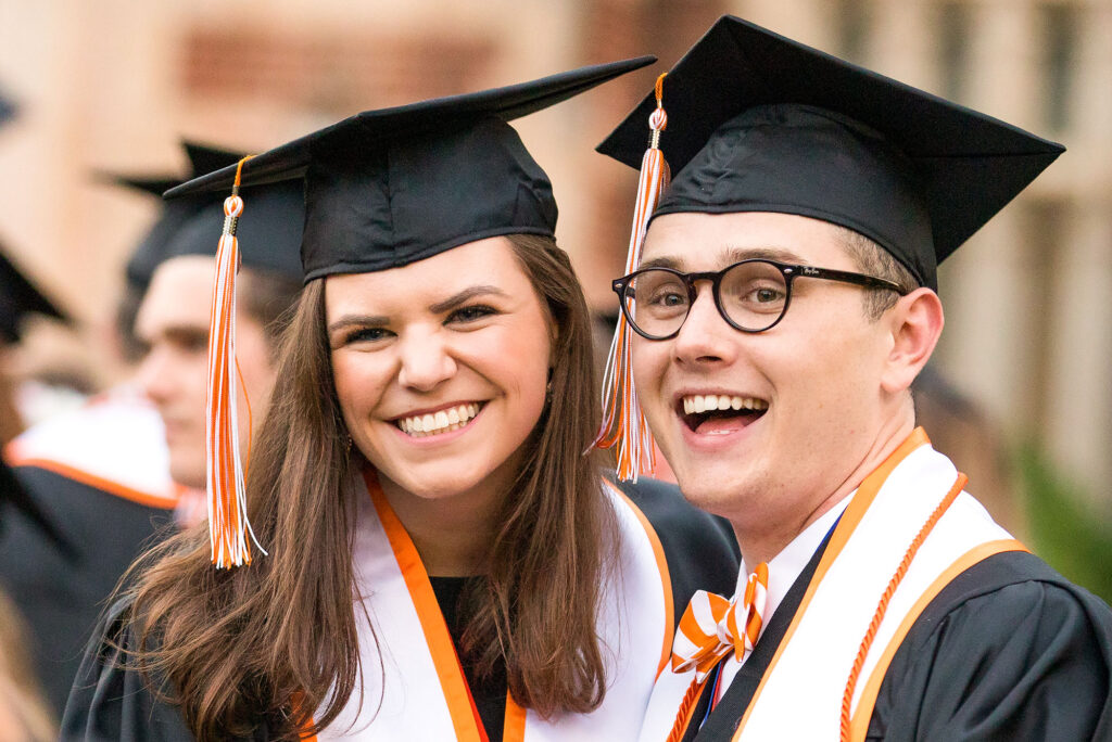 two graduates celebrate their achievement