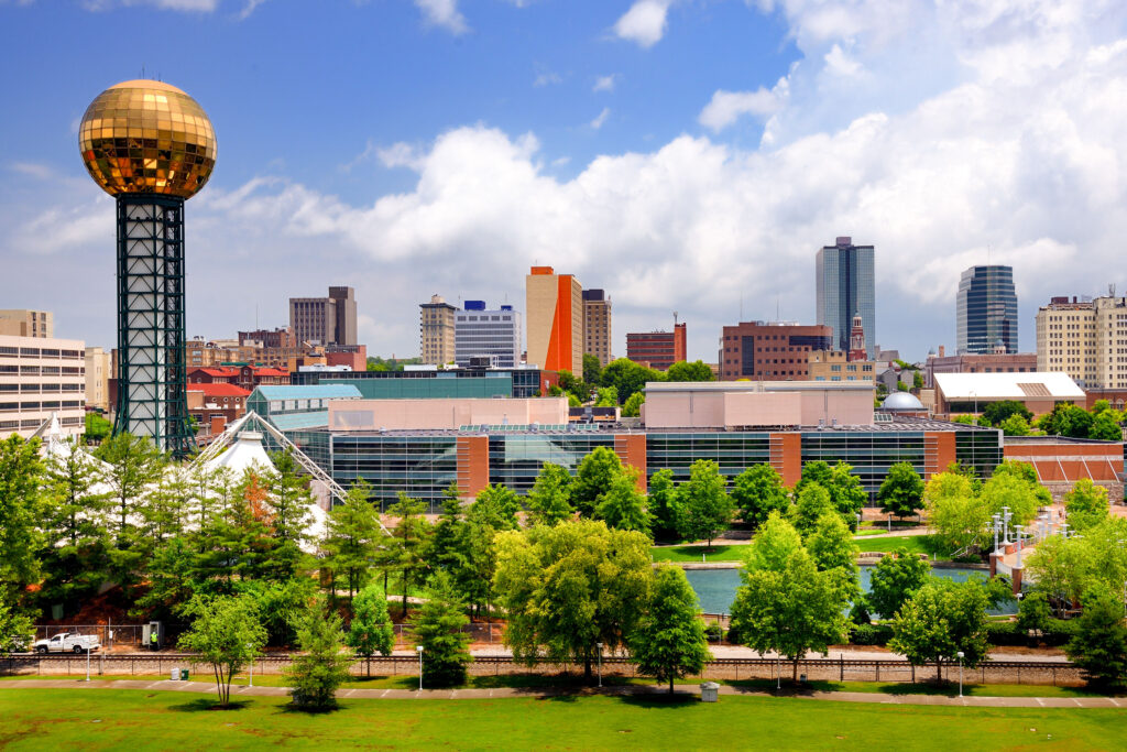 The city of Knoxville on a beautiful day with bright blue sky and the World's Fair Park in the foreground