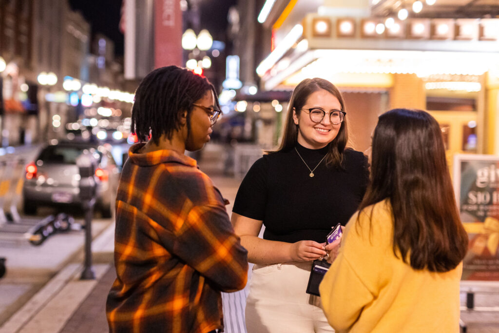 a group of friends gather downtown outside the theater to explore the city's nightlife