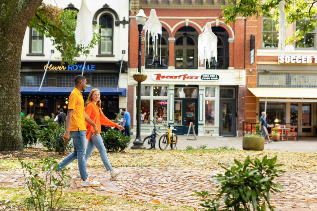 students proudly wear orange while walking through the center of Market Square located in downtown Knoxville