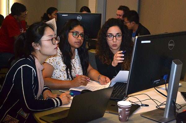 Three female students working on a computer