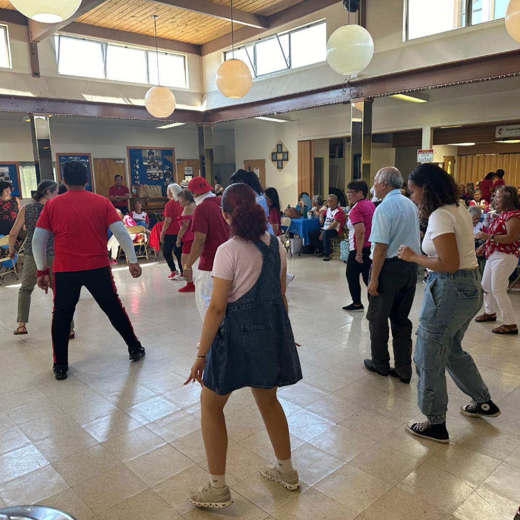 PEARLS scholars dance with older adults at the IDIC.