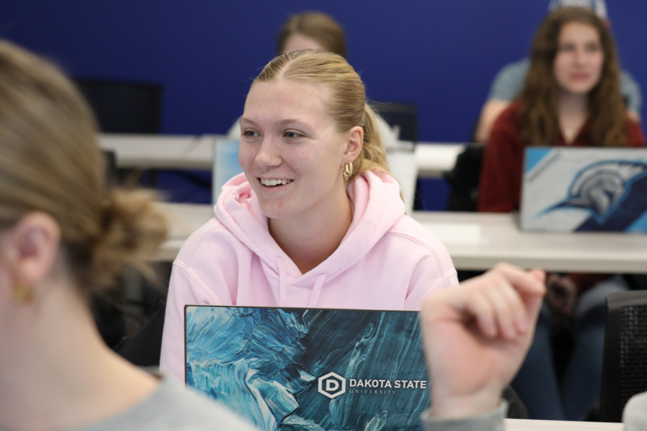 Student in classroom with laptop