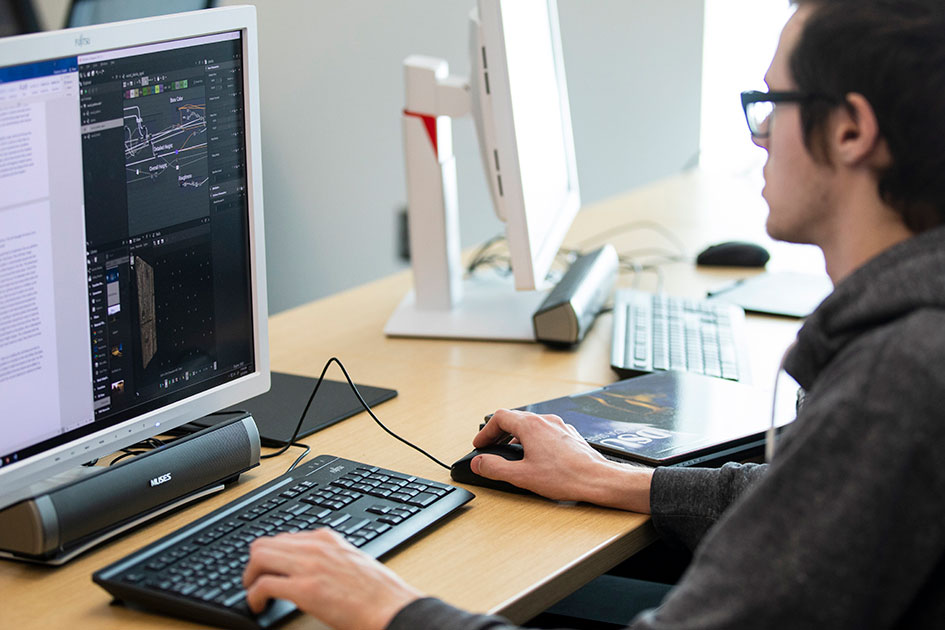 computer science student on a computer