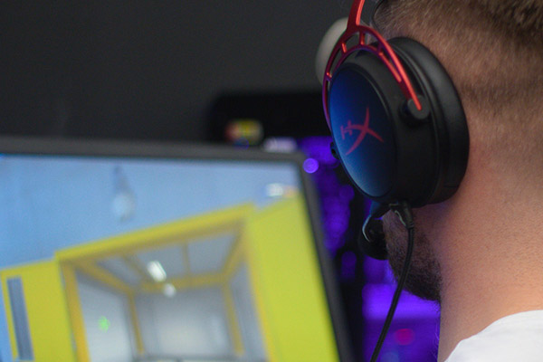 student at computer wearing headphones