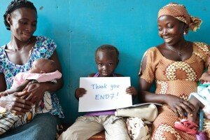 Saleimatu Kabia, 4, holds a sign reading "Thank you END7" at the Tombo community health center in the town of Tombo, Sierra Leone on Tuesday July 17, 2012.