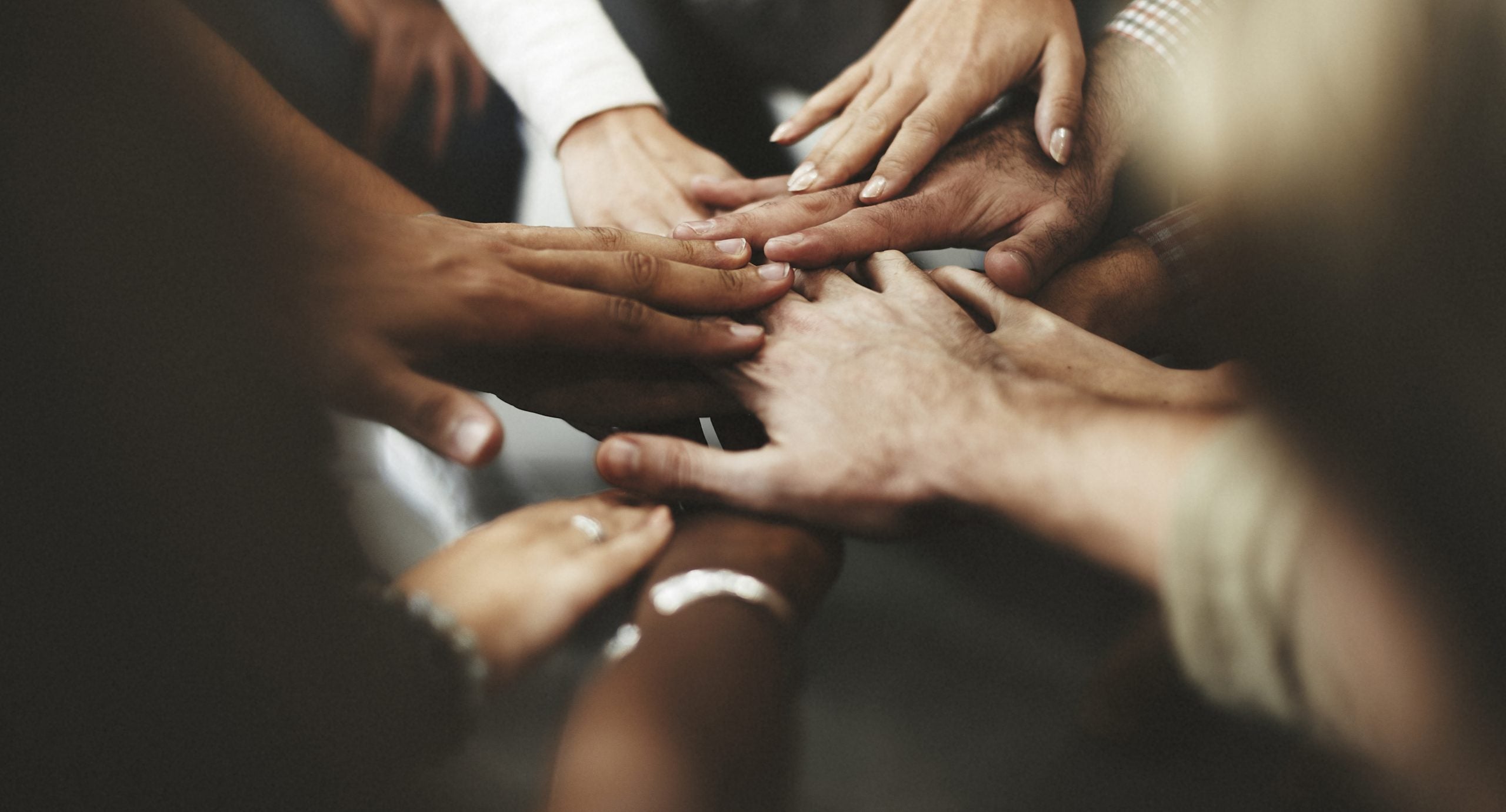 diverse hands coming together in support and solidarity