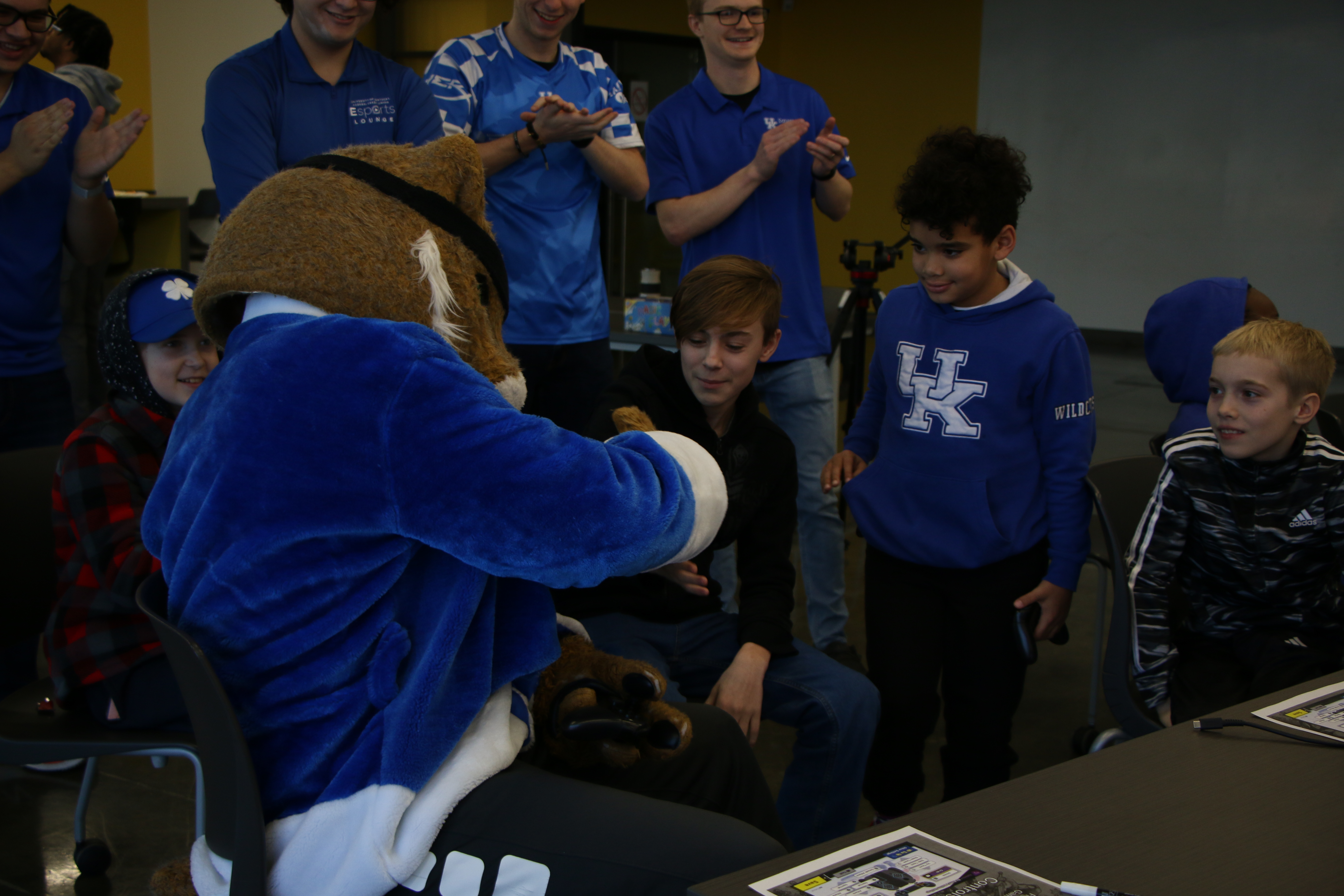 Wildcat fistbumping student