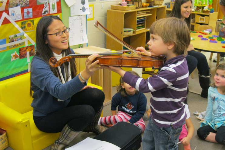 student with children in a classroom