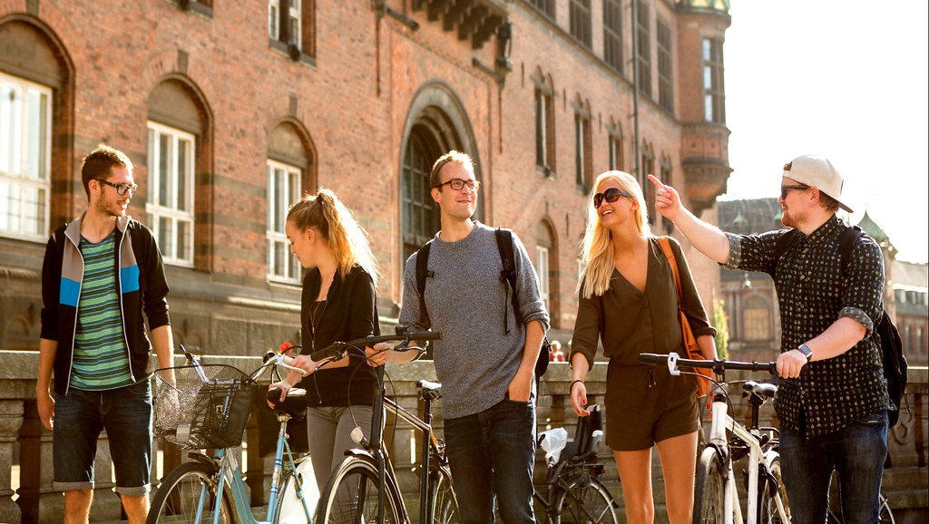 Four students walking through a European city