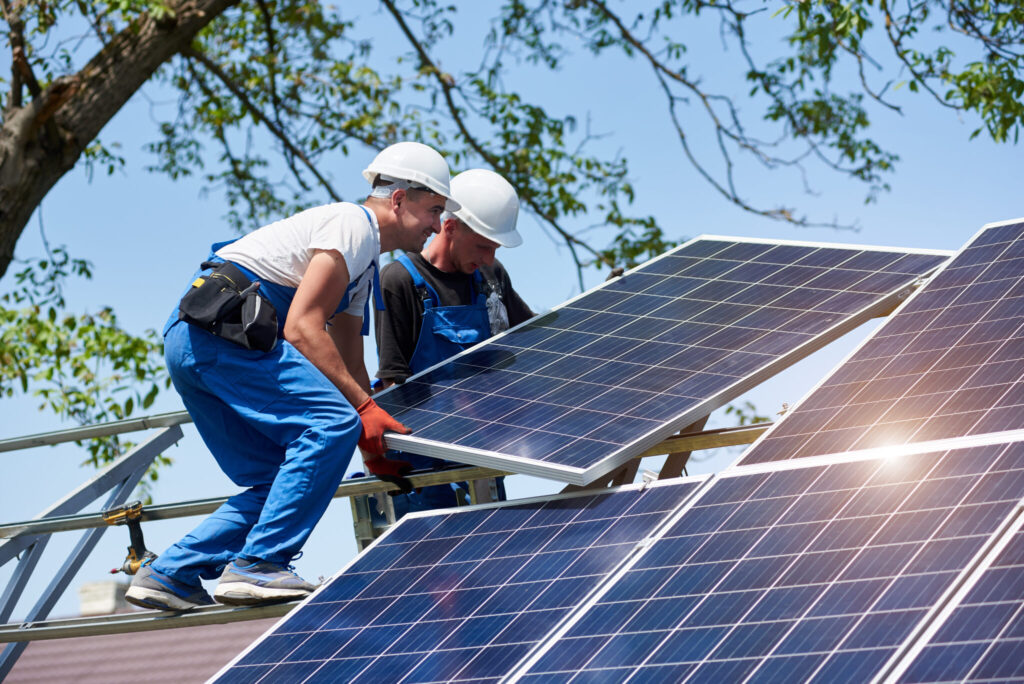 Solar contractors installing a rooftop panel