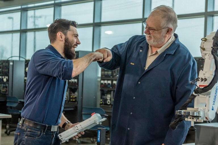 professor fist bumping student