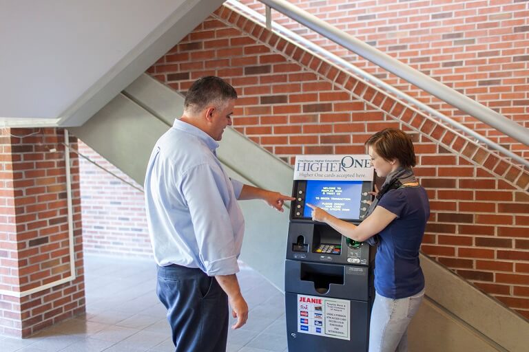 Female student in office speaking with a female financial aid counselor