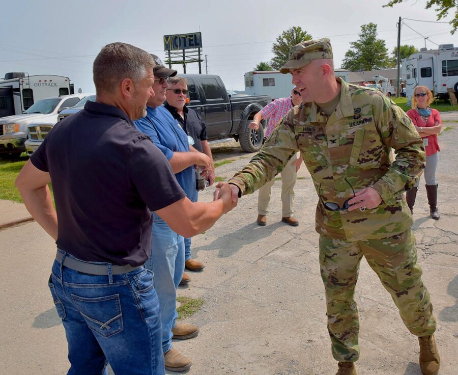 Two men shake hands.