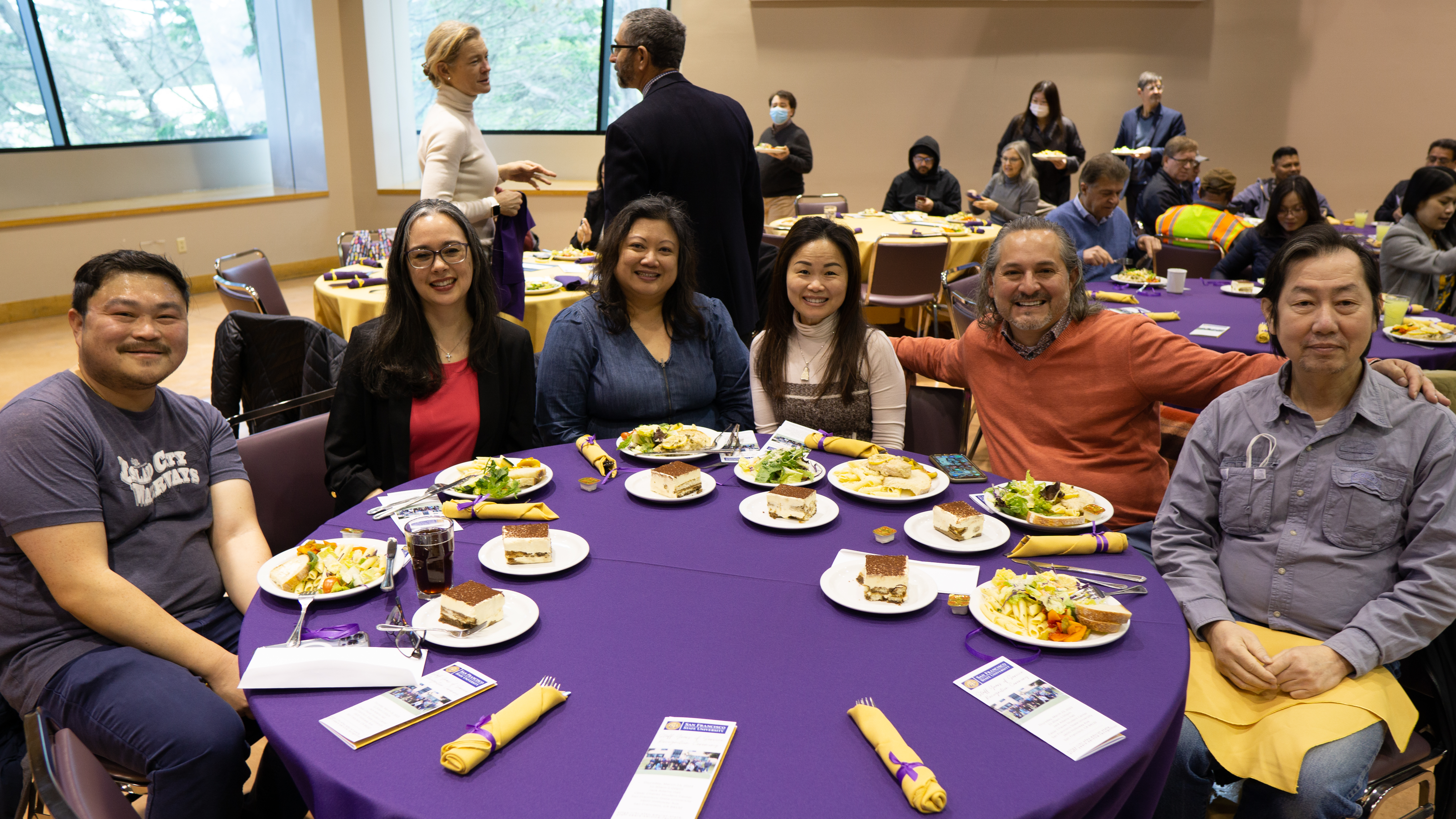 Group of male and female employees sitting at lunch together