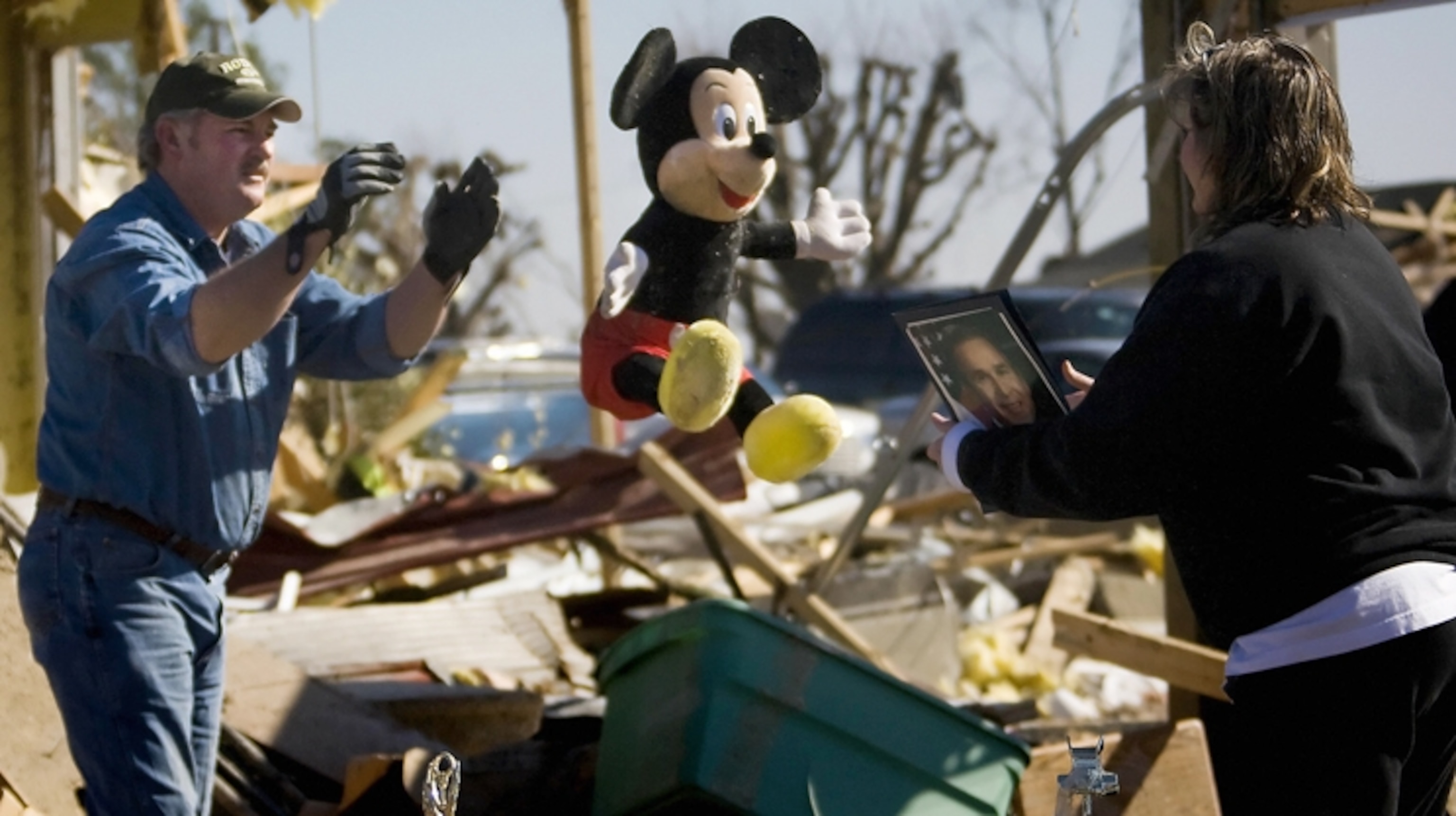 A man throwing a stuffed animal to a woman