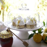 Stacked lemon bars topped with honey meringue and buttercream dragon bees