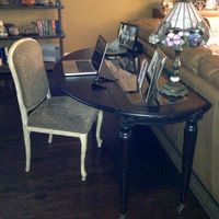 Putting a drop leaf table behind a couch does triple duty as a desk, sofa table and dining space.