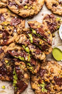 These soft and chewy vegan pistachio chocolate chip cookies are stuffed with pistachio cream, chopped pistachios, and gooey chocolate chips! Made with a nutty dairy free browned butter, no eggs and SO easy!