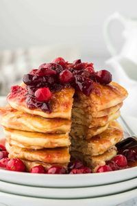 These perfectly spiced and fluffy eggnog pancakes recipe is topped with a homemade cranberry maple syrup making this the best holiday breakfast ever!  