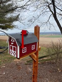 Beautiful hand crafted wooden mailbox by Amish artisans! This adorable mailbox is built to be durable with hand painted LP Smart Panel wood. Jake and John use this wood so that their creations can handle the elements. Zoom in on the photos to see the resulting texture of this material. Size: (L)22 x (W)12.25 x (H)15.5 (measurements at longest points) This gorgeous mailbox will be a wonderful addition to your yard and curb! Be sure to view our complete inventory of beautiful, unusual and handmade mailboxes at https://stonebridgecollections.com/collections/rustic-mailboxes Available in multiple box and trim colors. All have a black roof and red flag.Install on a mailbox post (not included) Please allow 10-14 days for delivery