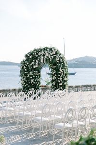 " ...From a ceremonial arch filled to the brim with luscioius white florals, to an exclusive set of tableware ordered to measure just for our beloved bride and groom, and from their greenery and white blooms laden details to their poolside reception everything worked to the finest seam! "