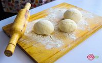 To make Bobby Flay's dough recipe, add sugar, bread flour, kosher salt and yeast to a bowl, followed by water and 2 tbsp oil. Beat the dough to make a ball, put some flour on the surface and start kneading it. Drizzle olive oil and cover the dough with plastic sheets. Let it rest and rise, so it becomes almost double in size.