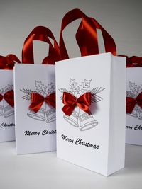 "Christmas Eve Treat bags, Gift Bags, Merry Christmas, Christmas bags as gift wrapping paper alternative for gifts, Traditional Christmas Bag Christmas Gift Bag for Christmas gifts. Bags can be personalized. Leave a note with the names. Size of bags to choose from: S- 5x4x1.6 \"(13x10x4 cm) M1- 8.5x5,2x2.5 \" (22x13.3x6.6cm ) M 2- 8.5x6.3x3 \"(22x16x8cm) L- 10x8x3\" (26X20X8CM) If you want a different color for the ribbon, leave a note. I send all boxes and bags flat, for safety reasons, so that