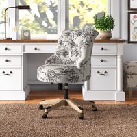 This swivel task chair features an elegant floral motif and button-tufted details for a French country look in your home office. The frame is made from solid wood, and it rests on a wooden base with metal caster wheels for easy mobility and a mixed-material design we love. A curled back and the rounded seat are upholstered in 100% polyester with hues of cream and gray. Foam filling adds lots of cushioned support while you tackle work projects or your latest DIY masterpiece. Plus, the seat height