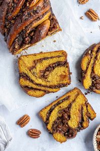 Vegan pumpkin pecan babka - this sweet, sticky loaf is full of the flavours of Autumn and is addictively good! A soft, brioche-like pumpkin bread dough is filled with a spiced, buttery brown sugar pecan filling and doused in syrup. The ultimate Fall treat!