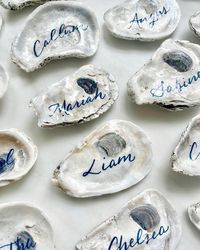 Oyster shell place cards with navy blue calligraphy by Nob Hill Jane for wedding at Griswold Inn in Connecticut.