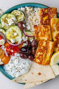 These Greek Bowls are easy, healthy and an absolute flavor party! With golden halloumi cheese, fresh veggies, tzatziki and Mediterranean flavors