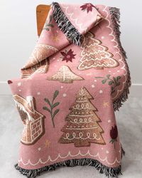 A 100% cotton throw blanket featuring a cute Gingerbread motif on a pink background. Woven with colored threads, not printed, for a beautiful texture & depth. 50x60 inches: most popular size, great for throwing on a sofa60x80 inches: cover a few people on a sofa, or use as a bedspreadEasy care: machine wash with cold water; tumble dry on low.Designed by me in Canada, and woven and shipped from the USA. Colors may vary slightly due to screen differences.