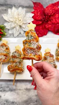 This fun, festive snack is easily a crowd pleaser for guests of all ages! These easy-to-grab mini baked sandwiches are excellent for Christmas parties. Topped with garlic butter and parmesan cheese. Creator: @chefgenevieve on TikTok