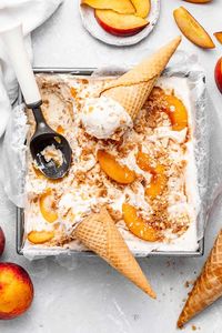 This Easy No-Churn Peach Pie Ice Cream has the most creamy smooth base filled with sweet spiced peach slices and perfectly crunchy pie crust bites. #icecream #nochurn #nochurnicecream #peach #peachpie #peachcobbler #peachicecream #peachpieicecream