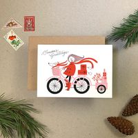 SEASON'S GREETINGS CYCLIST This card features Imogen's unique festive illustrations. Lovingly letterpress printed in black, pink and red. Printed on vintage presses in the UK on 350gsm FSC paper stock, supplied with matching envelope. 350gsm Cards are printed on vintage presses FSC paper