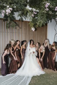 bridesmaids in mix and match brown gowns for an earthy and romantic boho beach wedding in Ibiza