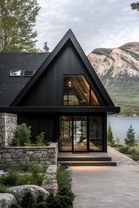 Modern cottage style mountain lake house with stone entryway wall black slatted siding black a frame roof full glass front entrance wall lake can. Check out all of these inspiring modern dark mountain houses that blend sleek design with nature’s rugged beauty for an exquisite home.