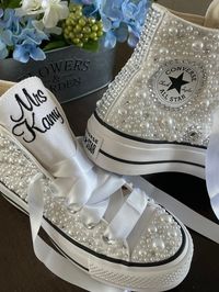 Platform Converse Hi Top with white mixed pearls and rhinestones encrusted all over the shoe. !  I can do all white pearls or all ivory. (I will do the white unless you ask for something else ) I can do No pearls on toes !! but you must write that in your order.  I can also do low top. check out my shop.  These shoes will sparkle and get noticed across the room!  They are beautifully embroidered and hand done and each pair will be a bit different. This listing shows the I Do pattern and will loo