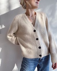 The Champagne Cardigan is worked from the top down with raglan increases on the yoke and a deep V-neck. The neckline of the cardigan is shaped with short rows by raising the back of the neck. The button plackets are worked in double knitting with buttonholes along the right side.