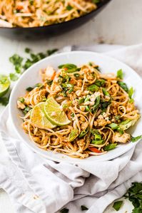 You won't know this healthy, easy recipe for Chicken Pad Thai isn't from your favorite authentic takeout spot! It's full of veggies, flavorful chicken, a creamy peanut sauce and only takes 30 minutes to make! Make it with a wok or a skillet.