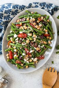 Mediterranean Green Bean Salad is full of bright flavors and colors, with Feta cheese, Kalamata olives, chickpeas, tomatoes and a tangy Greek vinaigrette.