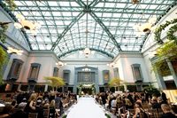 wedding ceremony harold washington library chicago tall ceiling skylight greenery chandelier garden