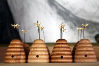 Made from pine and finished with beeswax and orange oil, these skeps are the perfect size for the teeny brass bee that gently sways in the breeze above its opening.