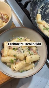 A non-spicy way to enjoy Korean Rice Cakes: Carbonara Tteokbokki! A creamy sauce made with parmesan cheese, whole milk, and bacon is perfect paired with soft and chewy Korean rice cakes. An easy snack or side dish to make in only 15 minutes! Enjoy this popular Korean street food with a creamy, cheesy sauce!