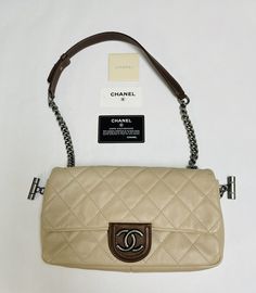 Authentic Original Chanel Classic Single Flap Bag Beige New with Tag Bag is Authentic Original from Chanel. Its new never been used. It was kept in a storage place and  its really not a it has few minor marks on bag for been in storage. Please see pictures for more details. Please message us if you have any questions.  Terms and Conditions: This item carry 30 days warranty covering repair or replacement. And 14 days for refunds with a 20% restocking fee. Return must be in the original condition and unused. RETURNS NOT ACCEPTED ON ITEMS LISTED "AS IS" OR "FOR PARTS & REPAIR". We do not warranty battery or software related issues. Batteries are AS-IS, they are not tested. Software is pre installed for you, but does not include recovery cd's or manuals. Buyers lack of knowledge of software, d Designer Flap Bag With Cc Turnlock For Daily Use, High-end Travel Shoulder Bag With Cc Turnlock Closure, Designer Beige Leather Flap Bag, High-end Beige Shoulder Bag With Branded Hardware, Beige Shoulder Bag With Cc Turnlock For Everyday Use, Everyday Beige Flap Bag With Cc Turnlock Closure, Beige Rectangular Flap Bag With Cc Turnlock Closure, Luxury Beige Flap Bag With Cc Turnlock Closure, Designer Beige Flap Bag With Detachable Strap