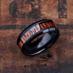 a black ceramic ring with wood inlay