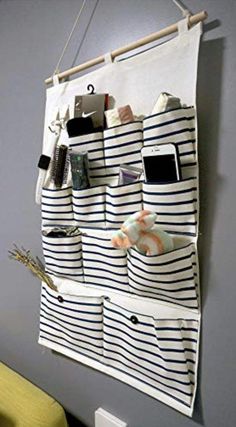 a wall hanging organizer with several pockets on it